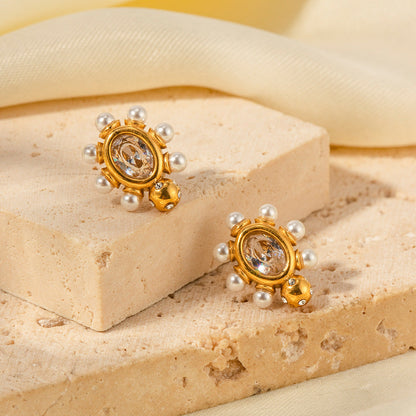 Elegante øreringe i guld med perle